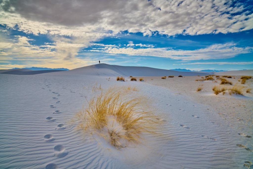 Woman hiker explores White Sands National Park, New Mexico.
